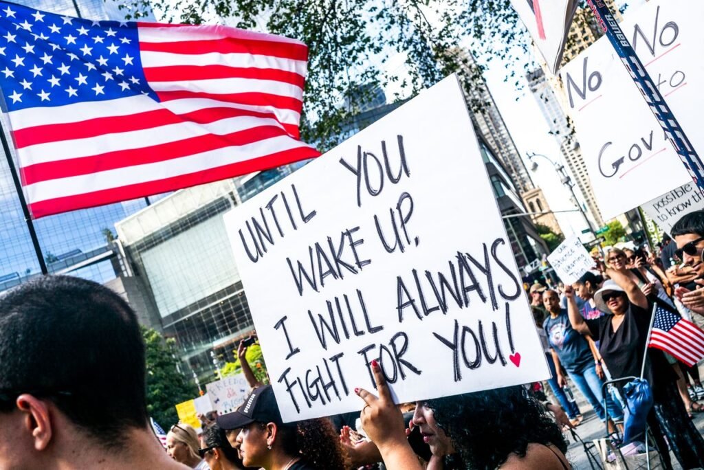 Protesters marching on a city street holding signs